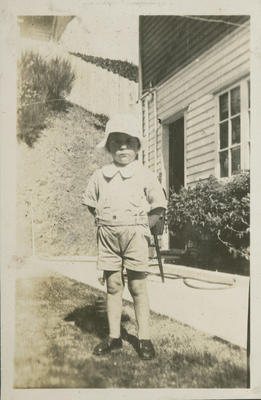 Young boy outside house